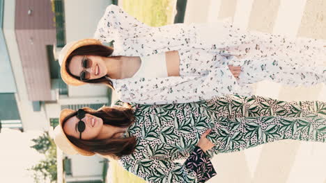 two women in fashionable summer outfits