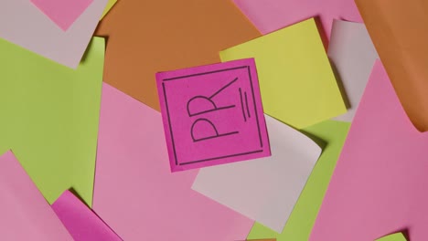 Business-Concept-Of-Revolving-Sticky-Notes-With-PR-Written-On-Top-Note