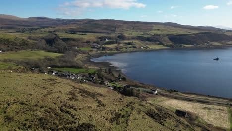 Rise-reveal-of-idyllic-Highland-village-next-to-shoreline-at-Idrigil-Bay-Uig-Isle-of-Skye-Scotland