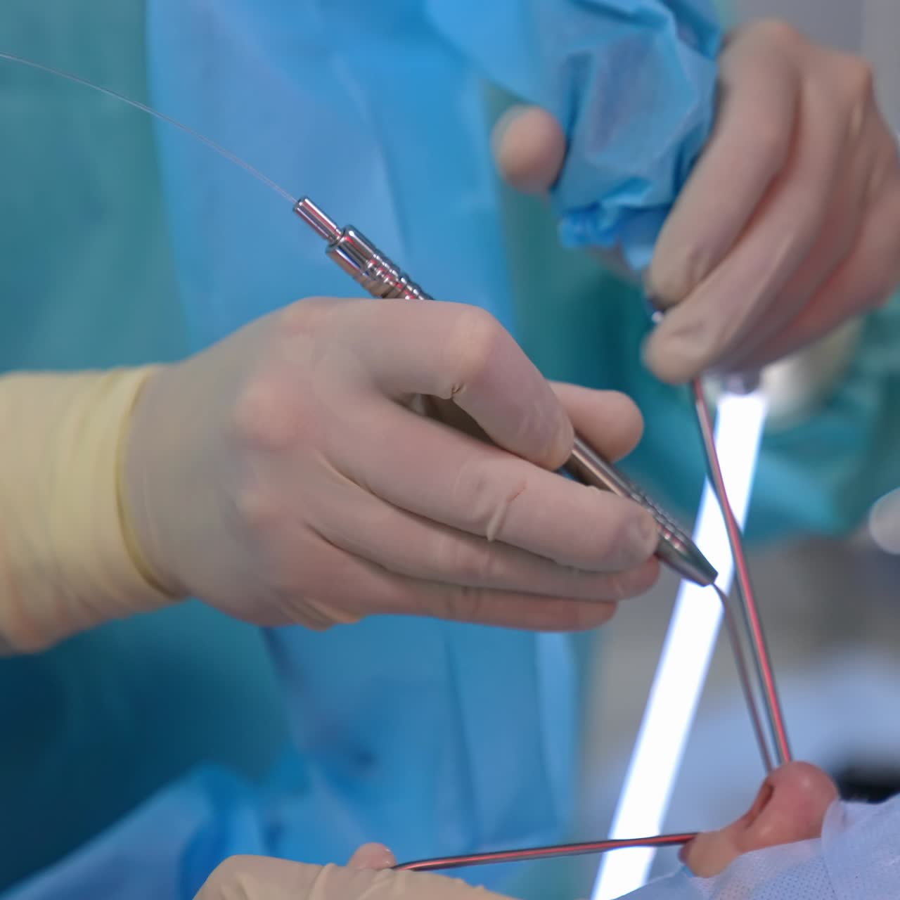 Operation on a patient's nose. Doctor's hands in sterile gloves doing surgery on a face with special instruments. Close-up