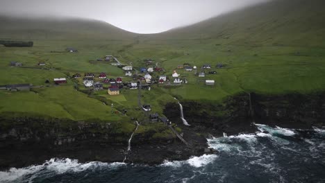 serene village on kalsoy island surrounded by dramatic cliffs, cascading waterfalls, lush green hills, and the vast ocean. this peaceful spot blends natural beauty and nordic charm in a remote setting