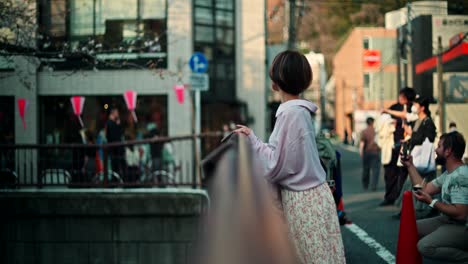 woman in a pink shirt in a japanese city