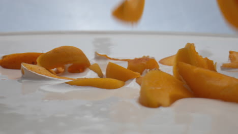 apricot dropped dairy dessert in super slow motion close up. healthy breakfast.