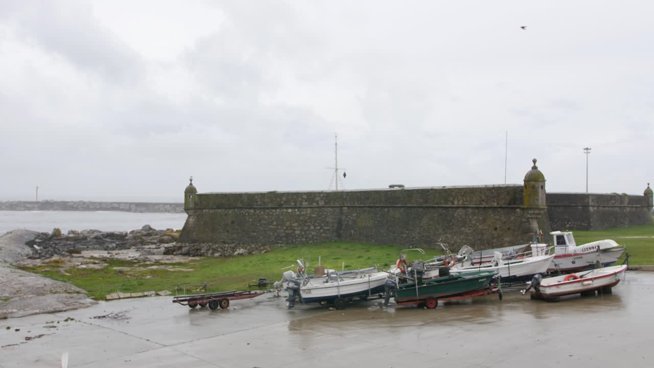 Old fortress with ocean surround and a few boats, footage take in north of Portugal, Vila Praia Âncora.