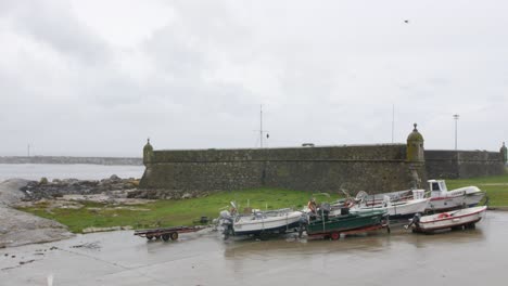 old fortress with ocean surround and a few boats, footage take in north of portugal, vila praia âncora.