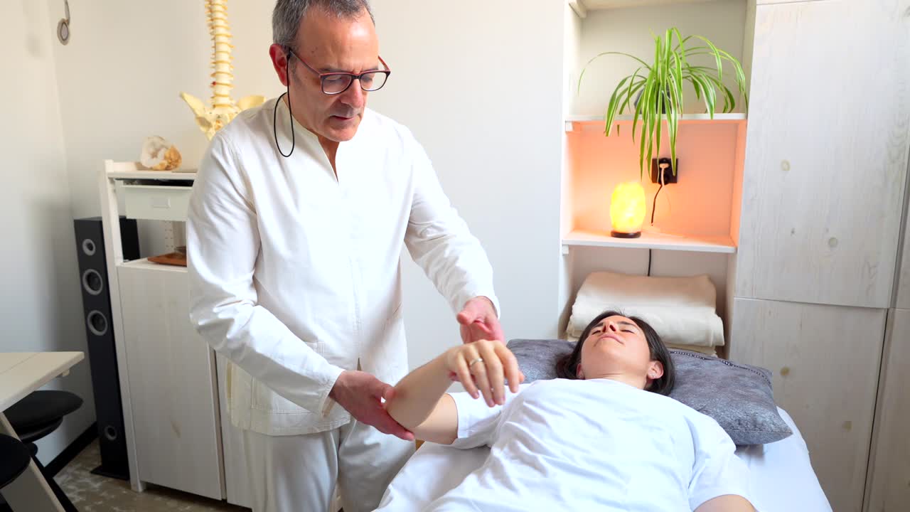 Chiropractor Examining a Patient