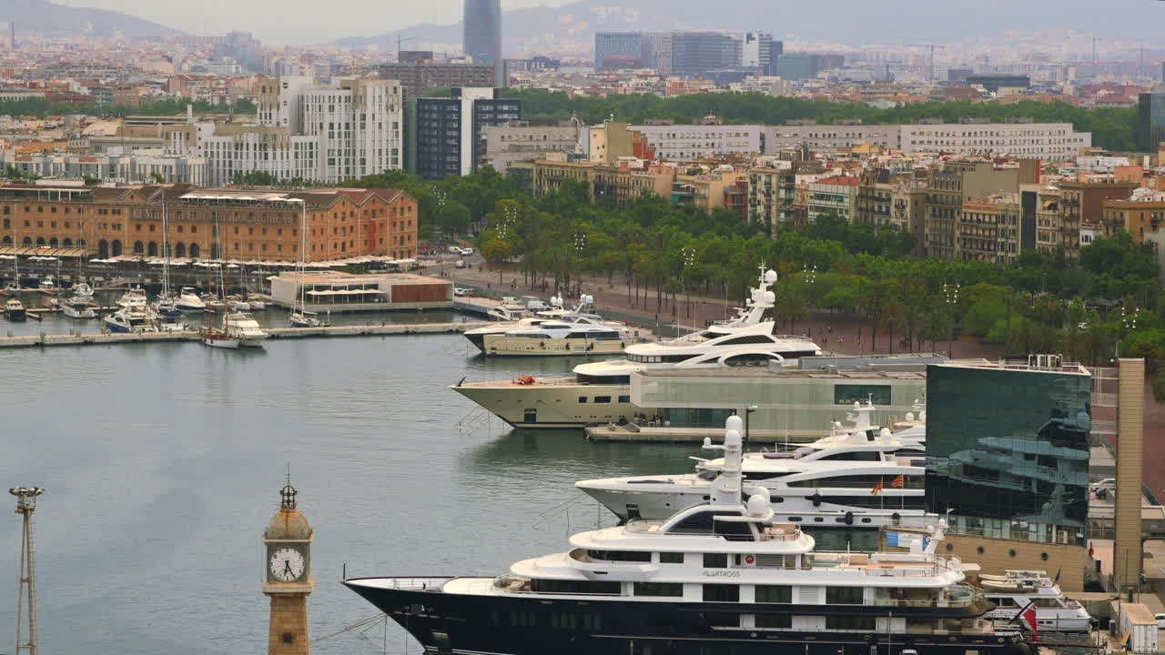 Barcelona, Spain - June 22, 2021: Aerial drone view of boats docked in the Port Vell