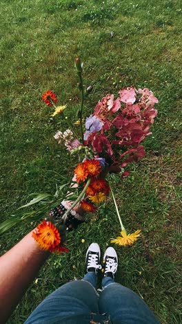 flowers held by a person in a garden