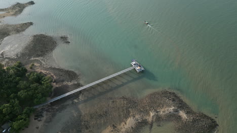 Aerial View of a Pier and Boat on a Coastal Bay