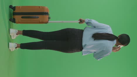 woman with suitcase on green screen