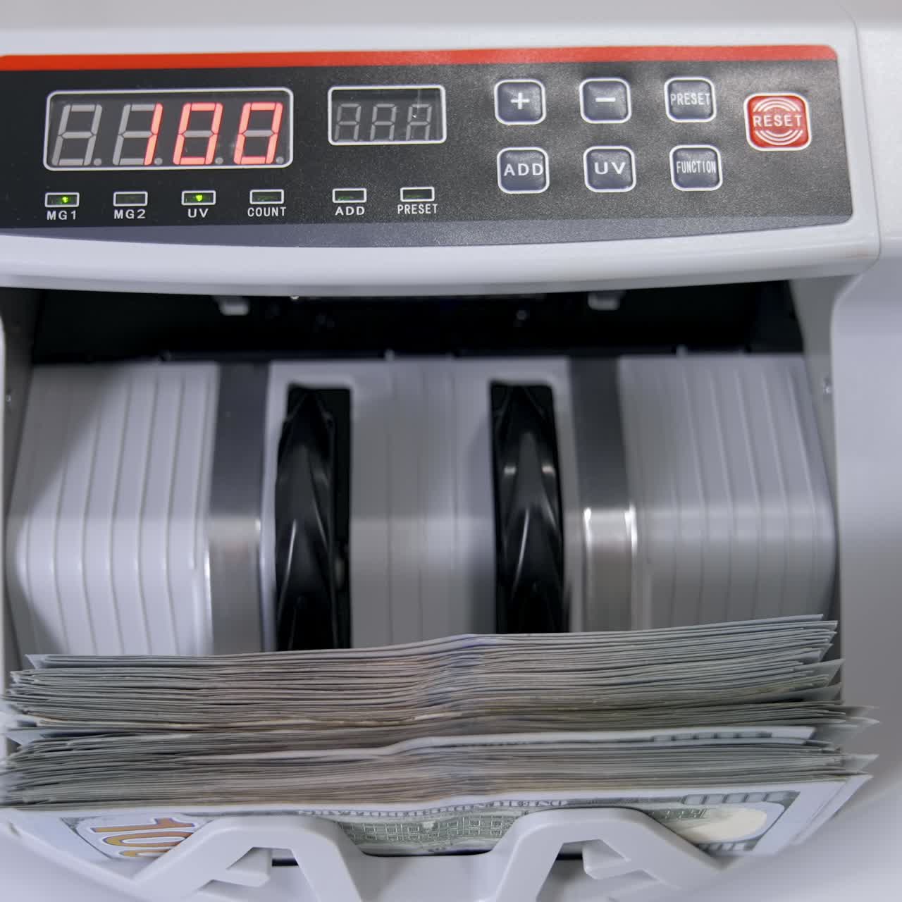 Automatic money counting in the machine. Electronic money machine is counting the dollar banknotes. Front view. Close-up