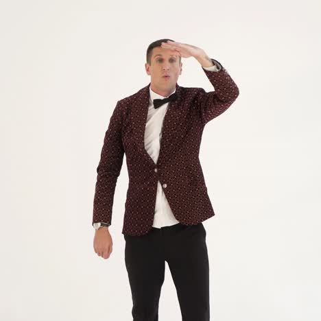 showman in a suit with a funny jacket is depicting a man who plays golf on a white background in the studio