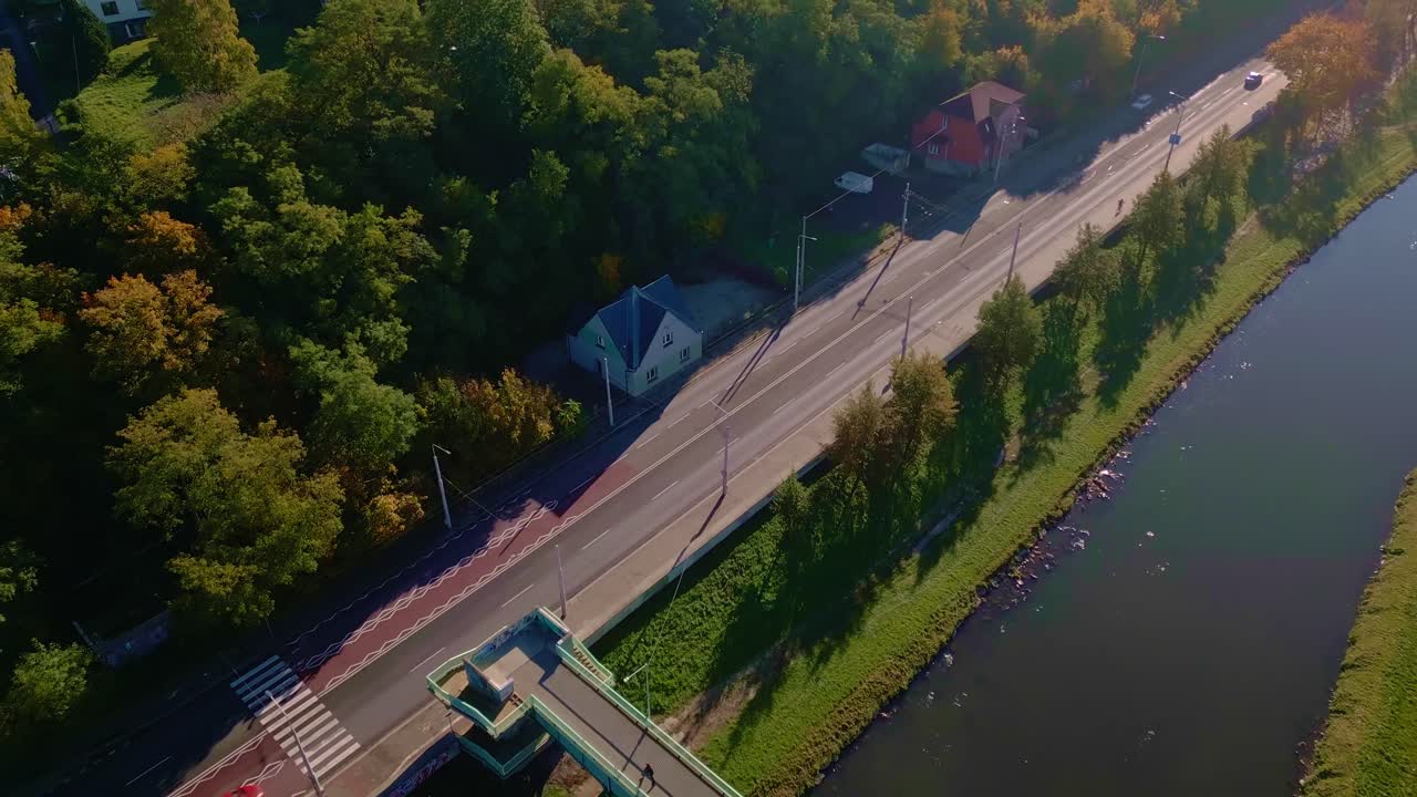 Drone reveals River Ostravice flowing next to main road during autumn