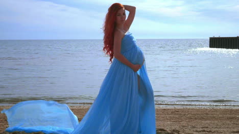 pregnant woman beach. pregnancy concept. pregnant lady in blue dress