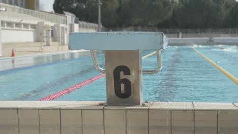 diving board at the montpellier swimming pool with swimmers in the background