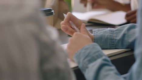 business woman hands writing taking notes in corporate meeting using pen close up