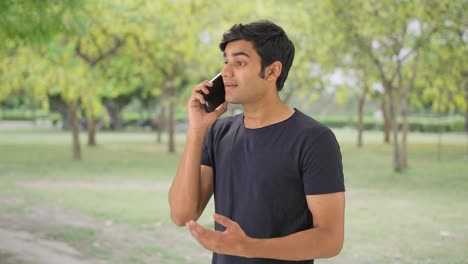 Indian-boy-talking-to-his-friends-on-call
