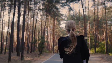 A-cheerful-girl-with-a-school-bag-runs-through-the-park