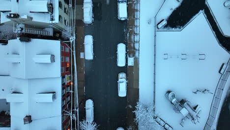 Top-down-of-snow-covered-trees-and-children-playground-in-urban-city-town-in-USA