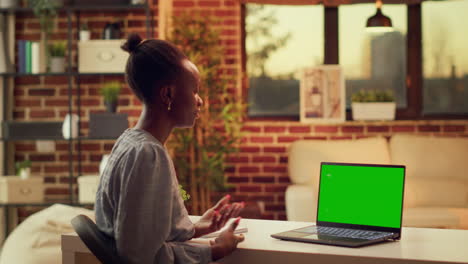 Woman-waves-at-greenscreen-on-pc