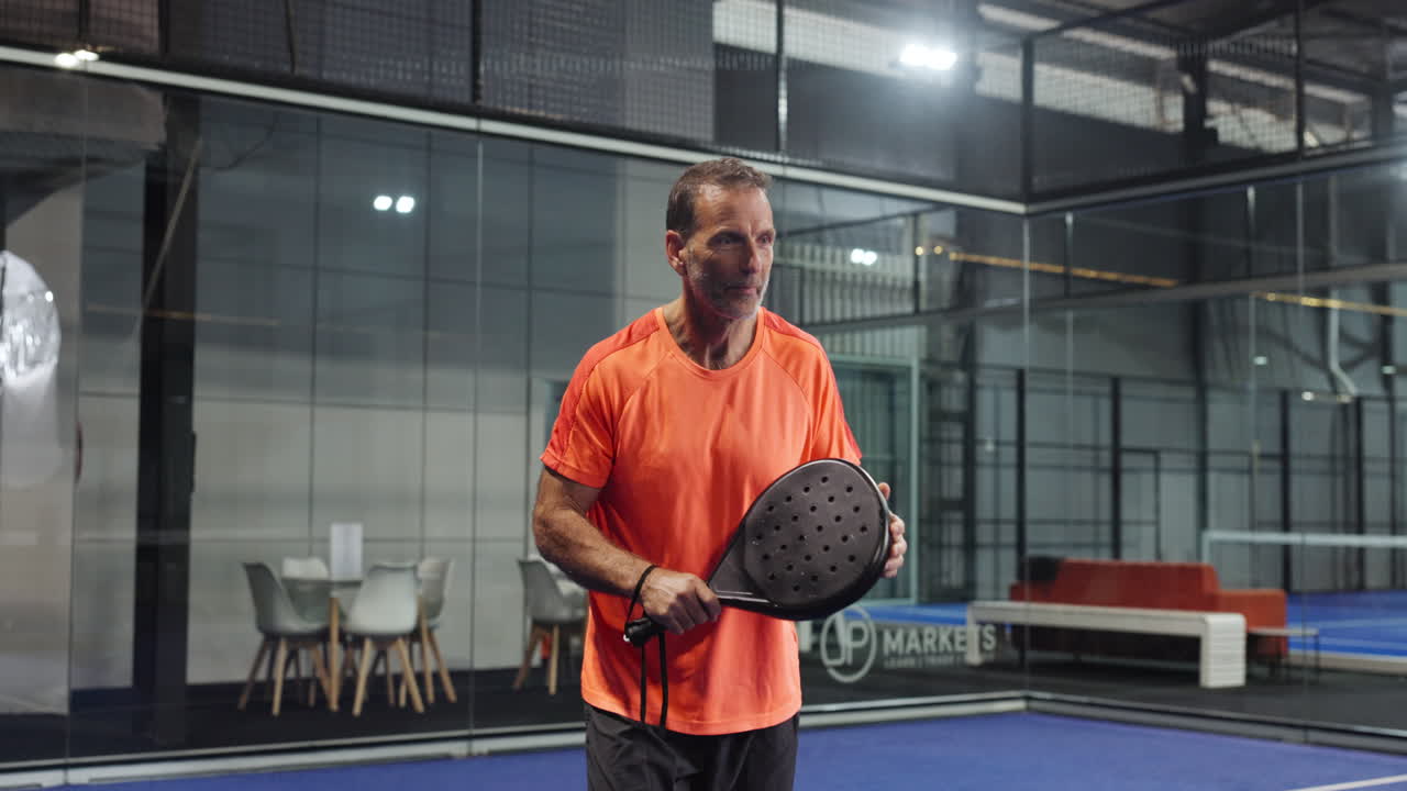 Man playing padel indoor