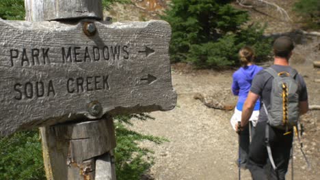 hikers follow sign to a meadow