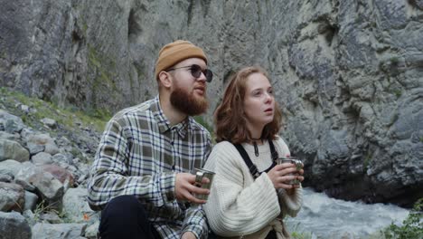 couple enjoying a drink in a mountain canyon