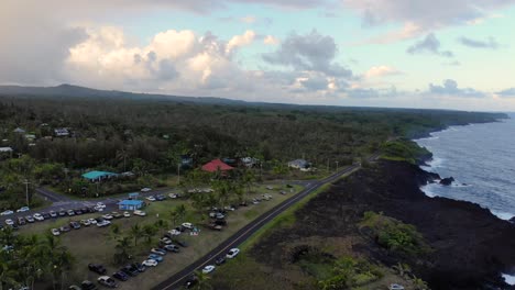 seaview lawn on hawaii island on a sunday evening with cars and people during sunset