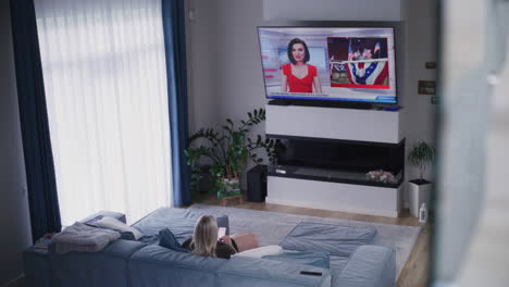 woman watching news on tv