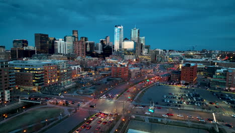 cinematic twilight aerial over speer boulevard with traffic, denver skyline view