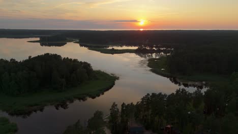aerial sunset view over dzirnezers lake in carnikava, latvia gauja village, siguļi, krievu island and distant baltic sea horizon in scenic natural landscape captured by drone