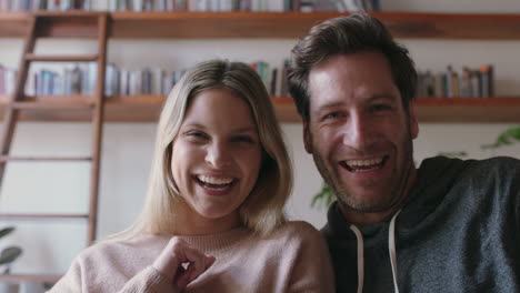 happy young couple video chatting using webcam waving at baby smiling excited enjoying online communication with friends