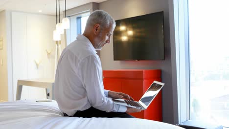 Businessman-using-laptop-in-hotel-room-4k