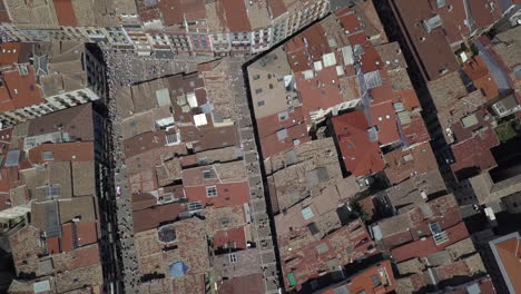 aerial looks down to tourist crowds on streets of pamplona, spain