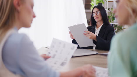 Confident-Businesswoman-Analyzes-Documents-During-Meeting