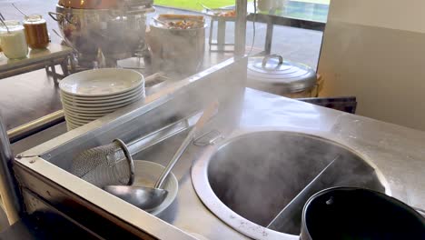 steaming noodles prepared at outdoor stall