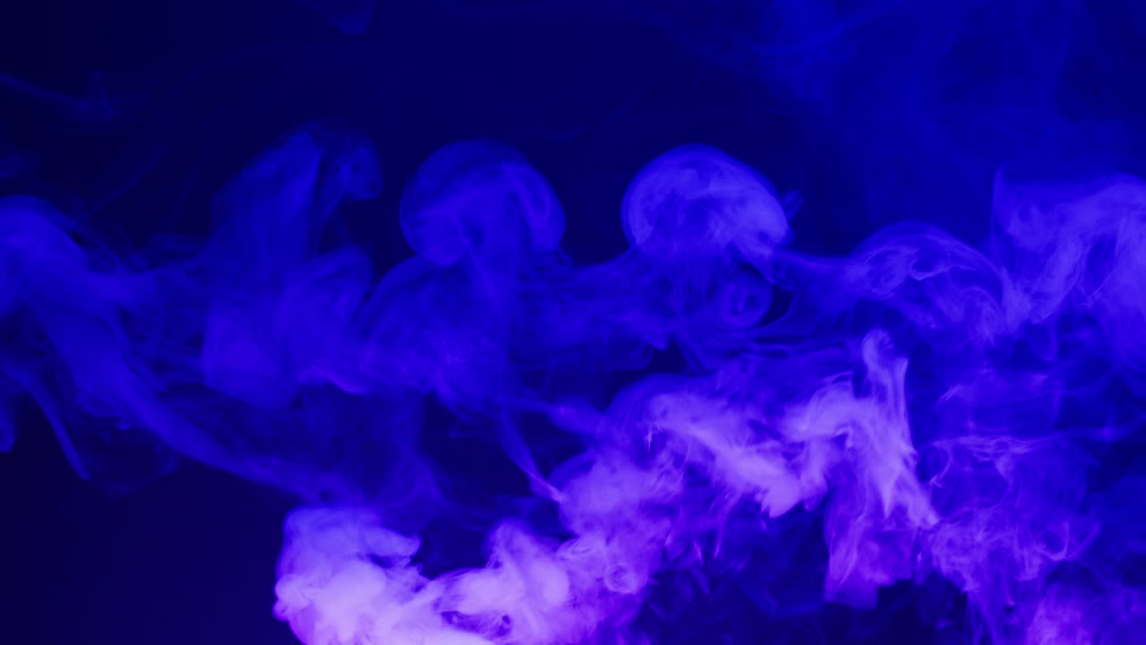 Vibrant Purple and Blue Smoke Swirling on Dark Background