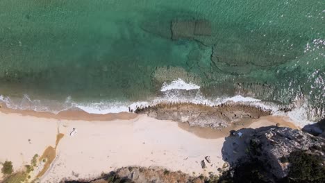 Overhead-drone-clip-over-beautiful-beach-with-waves-crushing-the-shore-in-Kavala,-Macedonia,-Greece