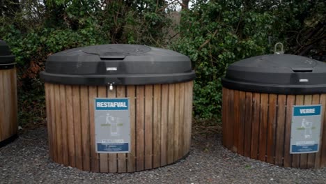 separated wooden waste bins for recycling in a row movement from left to right