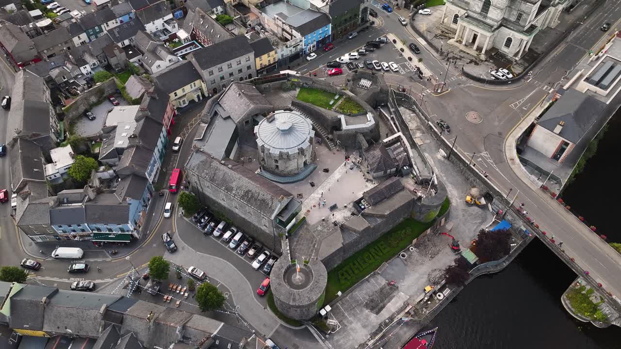 Aerial look down circling Athlone Castle, small Irish town on river Shannon. Urban cityscape