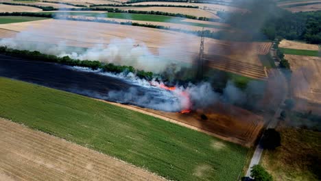 Farm-Field-In-Fire---aerial-drone-shot