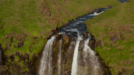 Aerial-view-of--Seljalandsfoss-waterfall-in-Iceland,-the-most-famous-cascade-in-Iceland.-Look-up-birds-eye-revealing-amazing-panorama-and-magnificent-waterfall
