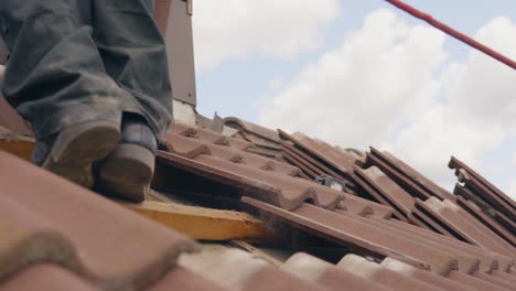 Roofing-scene-of-worker-removing-roof-tile-to-make-space-for-solar-panel