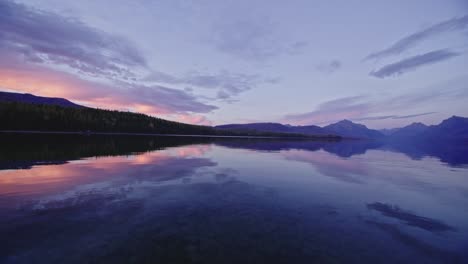 autumn scene looking across lake at colorful sunset at lake mcdonald in montana