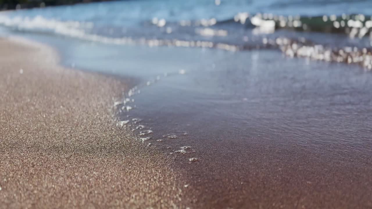 -4K resolution 3840x2160 video -Close-Up shot from sea side. Wet Sand and Sea Waves