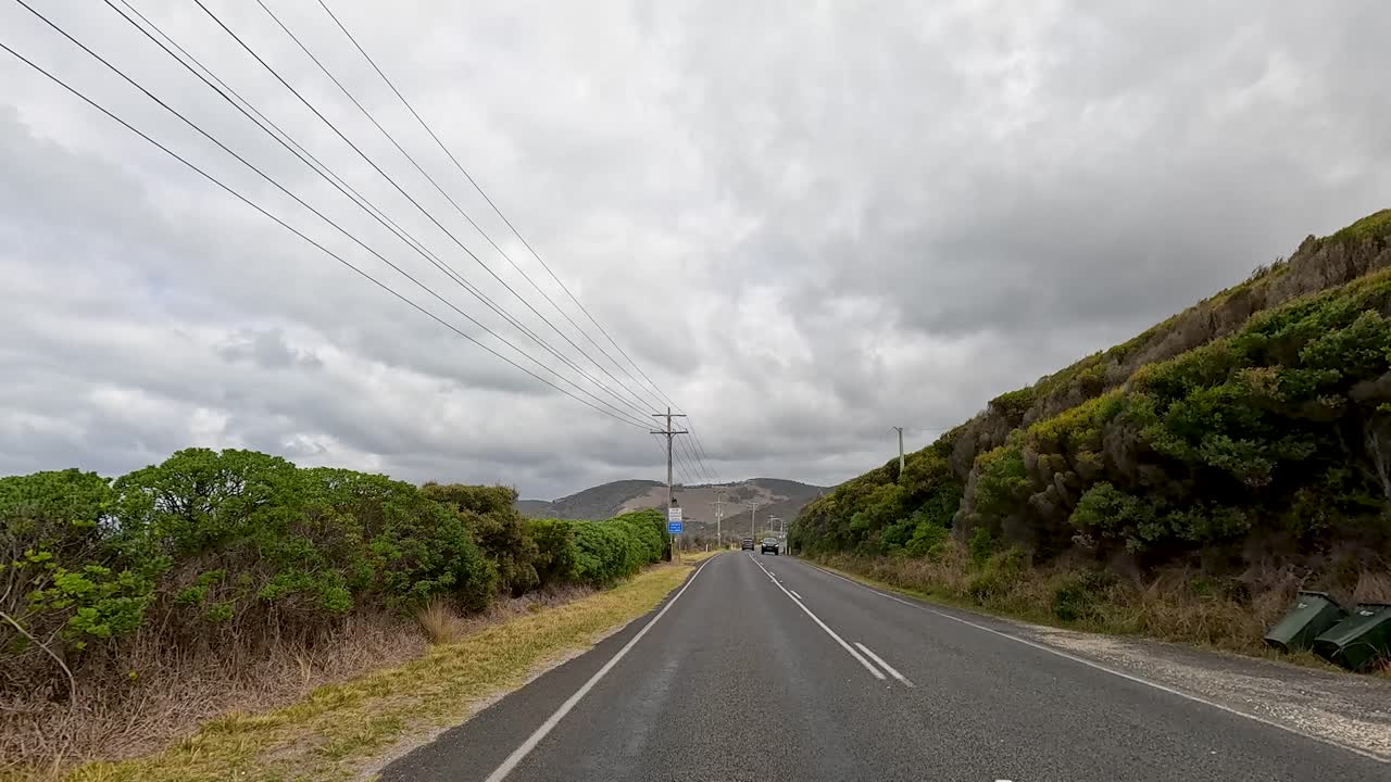 A 35-second video captures a drive along the Great Ocean Road, showcasing coastal landscapes and lush greenery under overcast skies