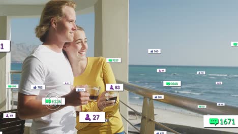 múltiples iconos digitales con números crecientes sobre una pareja caucásica bebiendo café en el balcón
