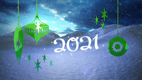 2021 text and christmas decorations hanging against snow falling over winter landscape