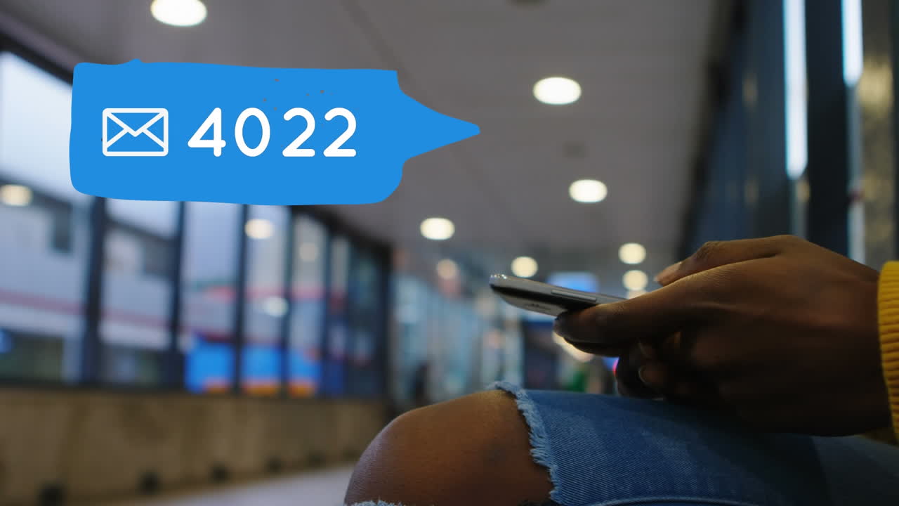 Person waiting sitting at a terminal while checking messages on social media