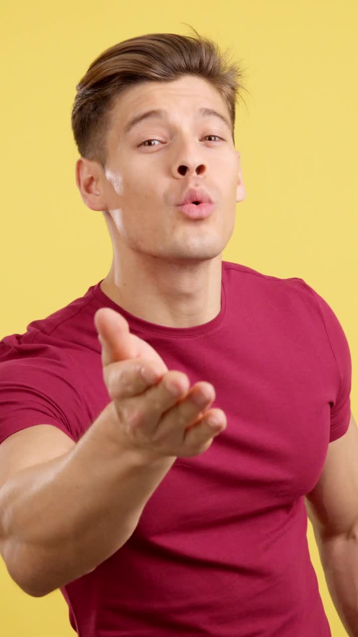 Man Blowing a Kiss on a Yellow Background